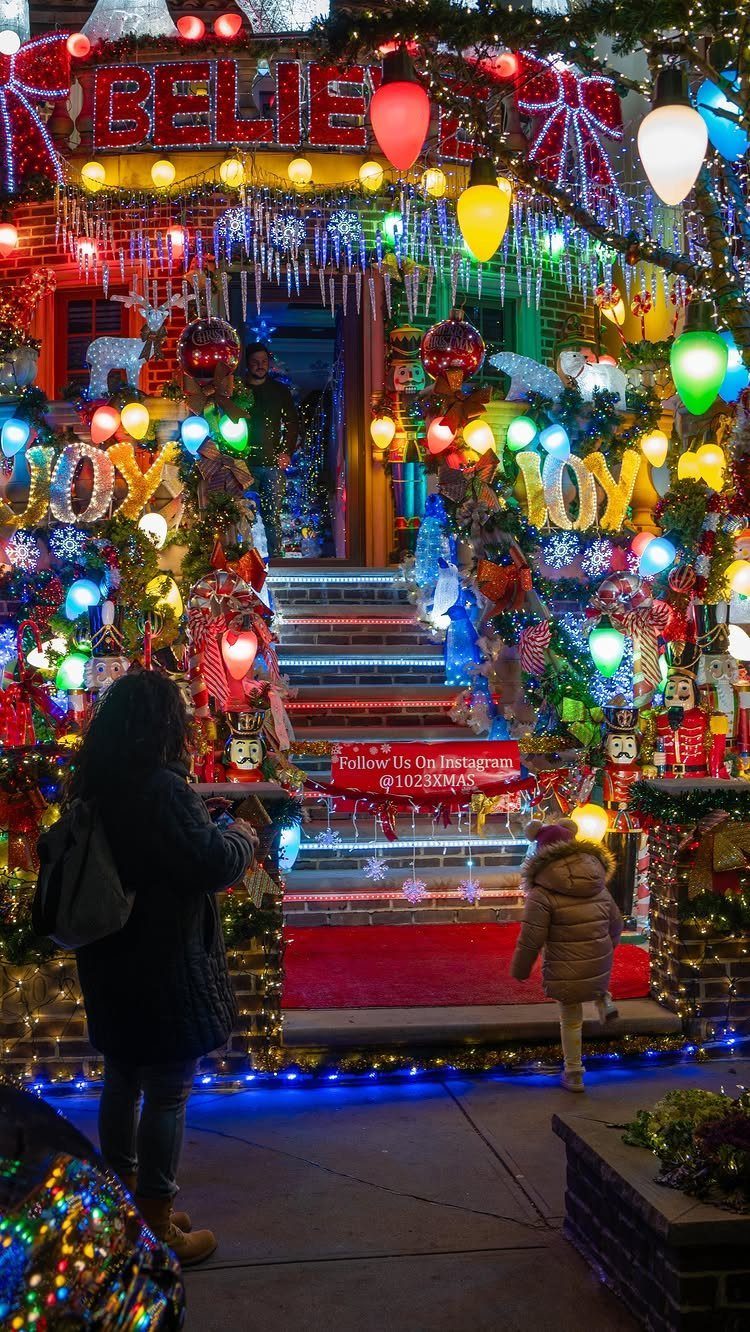 27 Christmas Display Ideas for Every Room of the Home 14 A house exterior covered in bright, colorful Christmas lights and festive holiday decorations.