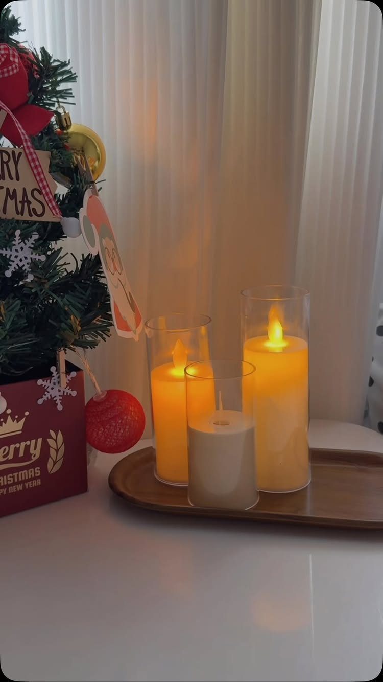 27 Christmas Display Ideas for Every Room of the Home 6 Three glowing flameless candles on a wooden tray next to a small Christmas tree.