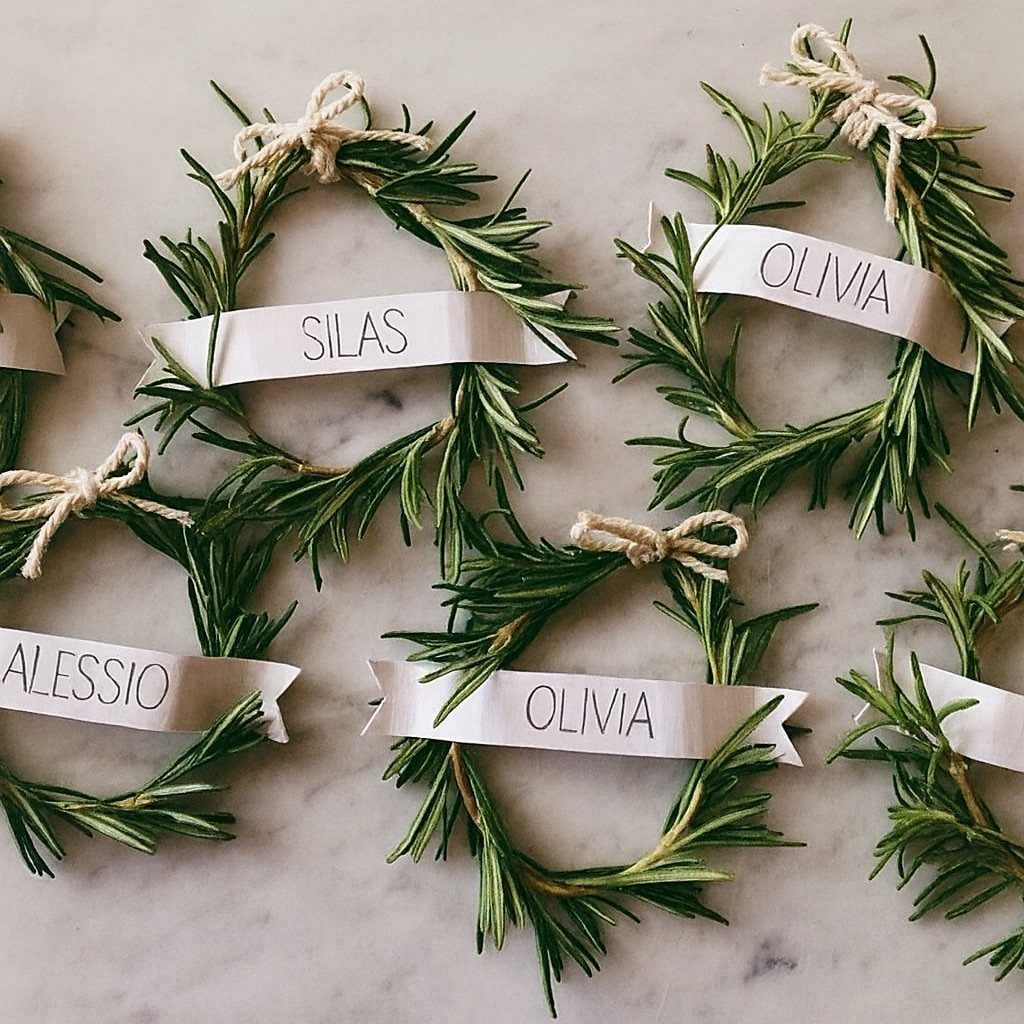 27 Christmas Display Ideas for Every Room of the Home 15 Small rosemary wreaths with white paper name banners resting on a white marble tabletop.