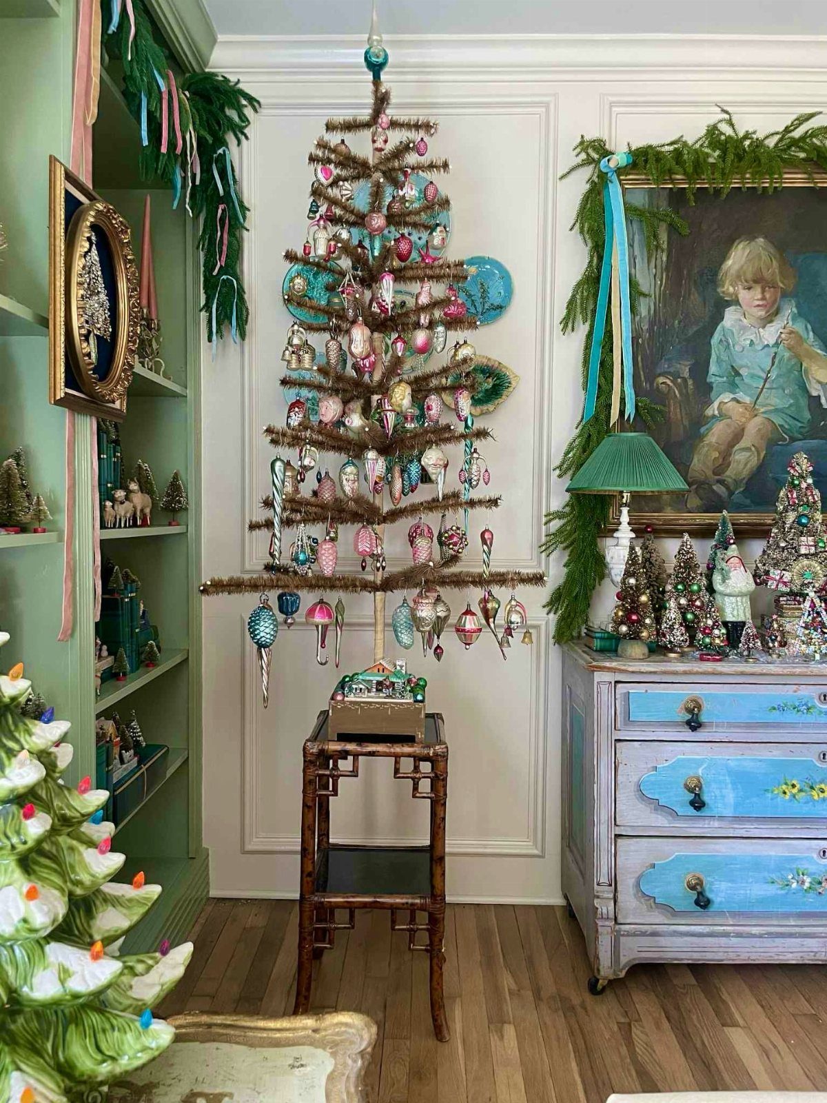 27 Christmas Display Ideas for Every Room of the Home 7 Vintage ornaments hanging from a minimalist wooden branch tree in a decorated room.