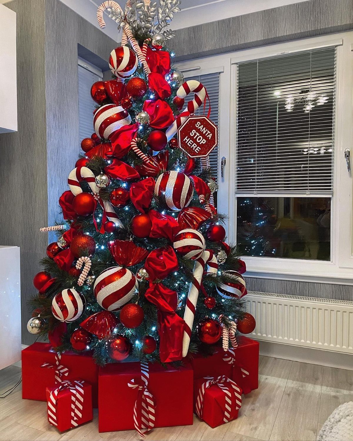 Christmas Tree Decor Ideas for 2025: 17 Fresh Styles from Coastal to Candyland 11 Decorated Christmas tree with red and white striped ornaments, candy canes, and red bows.