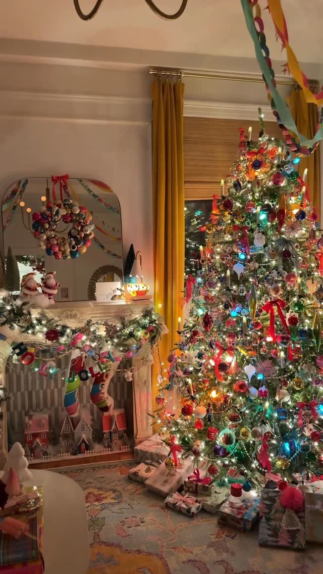 Christmas Tree Decor Ideas for 2025: 17 Fresh Styles from Coastal to Candyland 8 A brightly decorated Christmas tree with colorful ornaments and lights next to a fireplace.