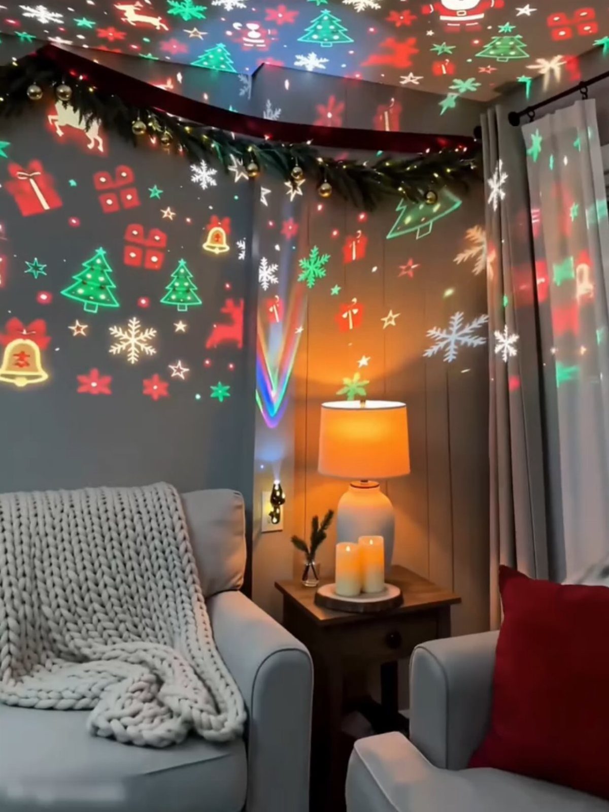 Christmas Wall Decor Ideas: 9 Ways to Dress Vertical Space 8 Christmas light projections of snowflakes and trees decorating a living room wall and ceiling.