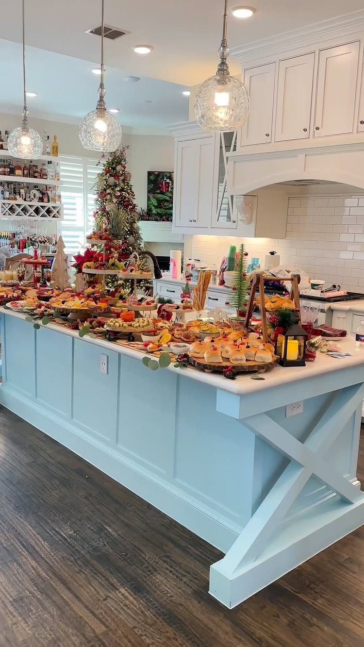 32 Easy Christmas Party Ideas for Food, Drinks, and Hosting in 2026 4 A large kitchen island filled with various festive holiday appetizers and finger foods.