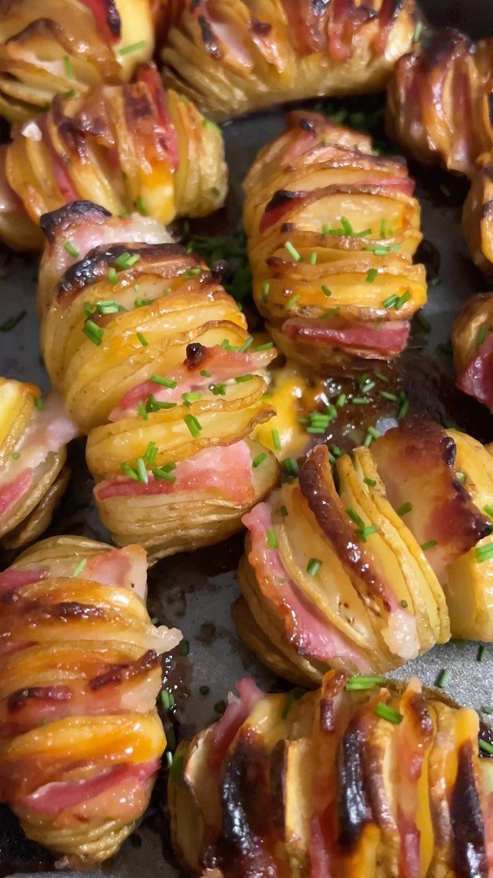 32 Easy Christmas Party Ideas for Food, Drinks, and Hosting in 2026 32 Hasselback potatoes stuffed with melted cheese and ham, garnished with fresh green chives.