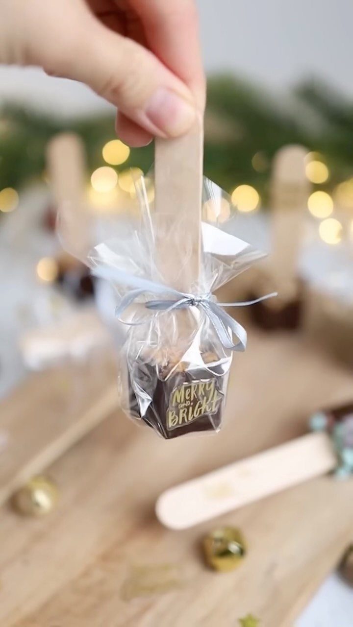 17 Easy DIY Christmas Gifts: Handmade Presents for Every List 3 A hand holding a wrapped chocolate stir stick with Merry and Bright text.