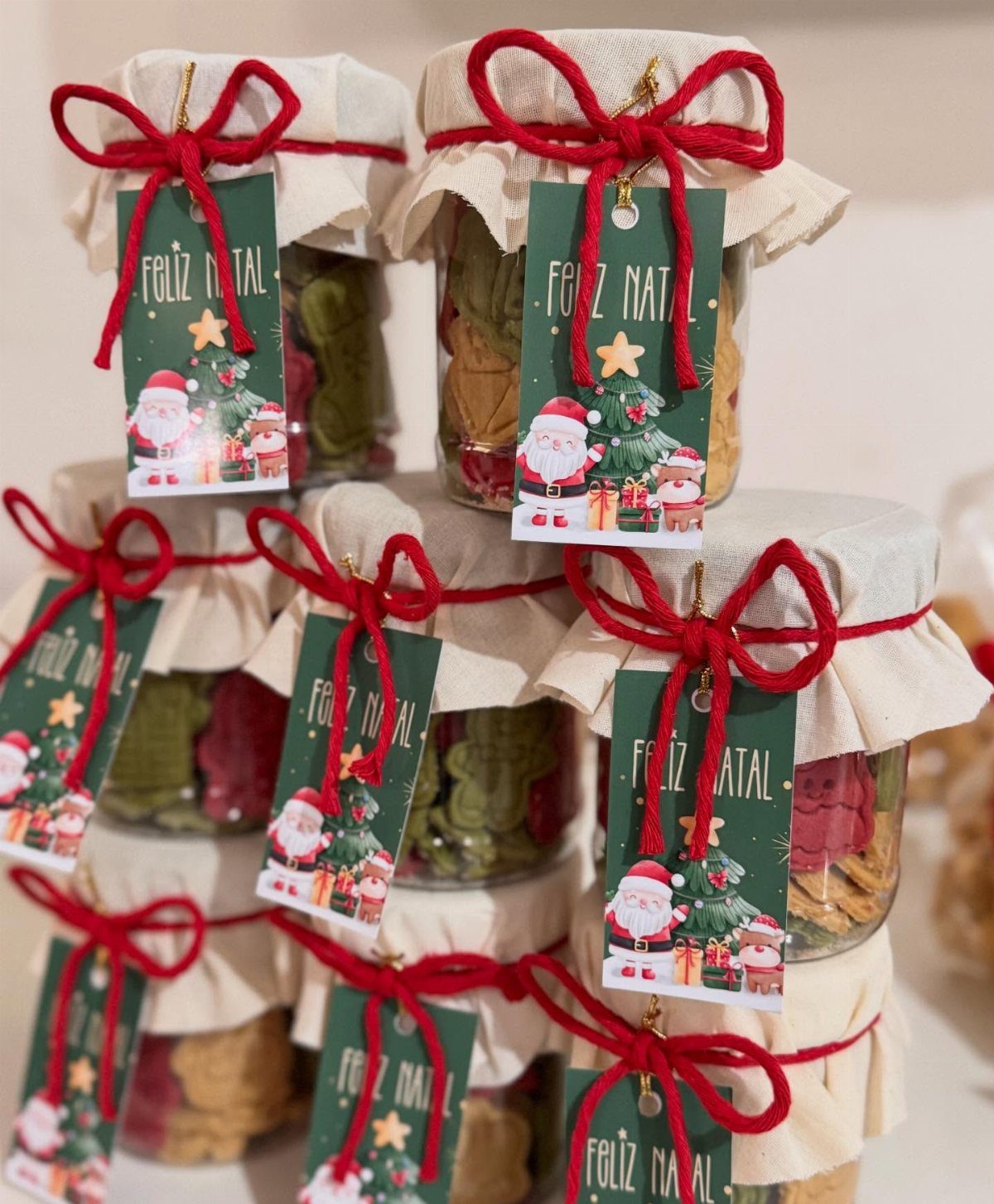 17 Easy DIY Christmas Gifts: Handmade Presents for Every List 5 Mason jars filled with assorted cookies, decorated with red bows and festive Christmas gift tags.