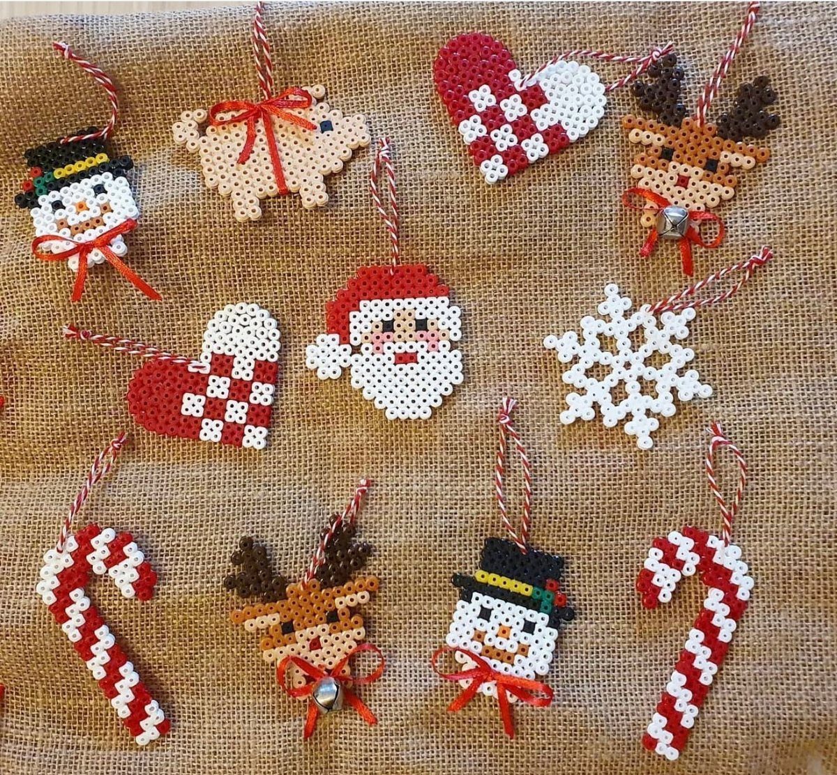 17 Easy DIY Christmas Gifts: Handmade Presents for Every List 4 Perler bead Christmas ornaments featuring Santa, reindeer, snowmen, and candy canes on burlap.