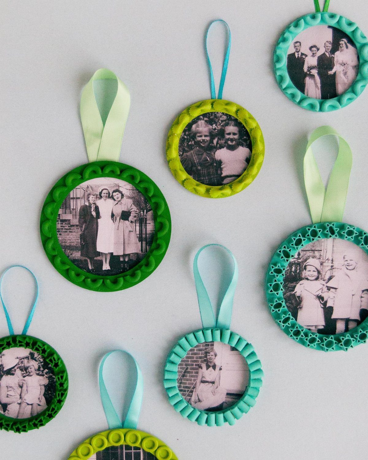 Circular ornaments with colorful pasta borders featuring vintage black and white photographs and ribbon loops.