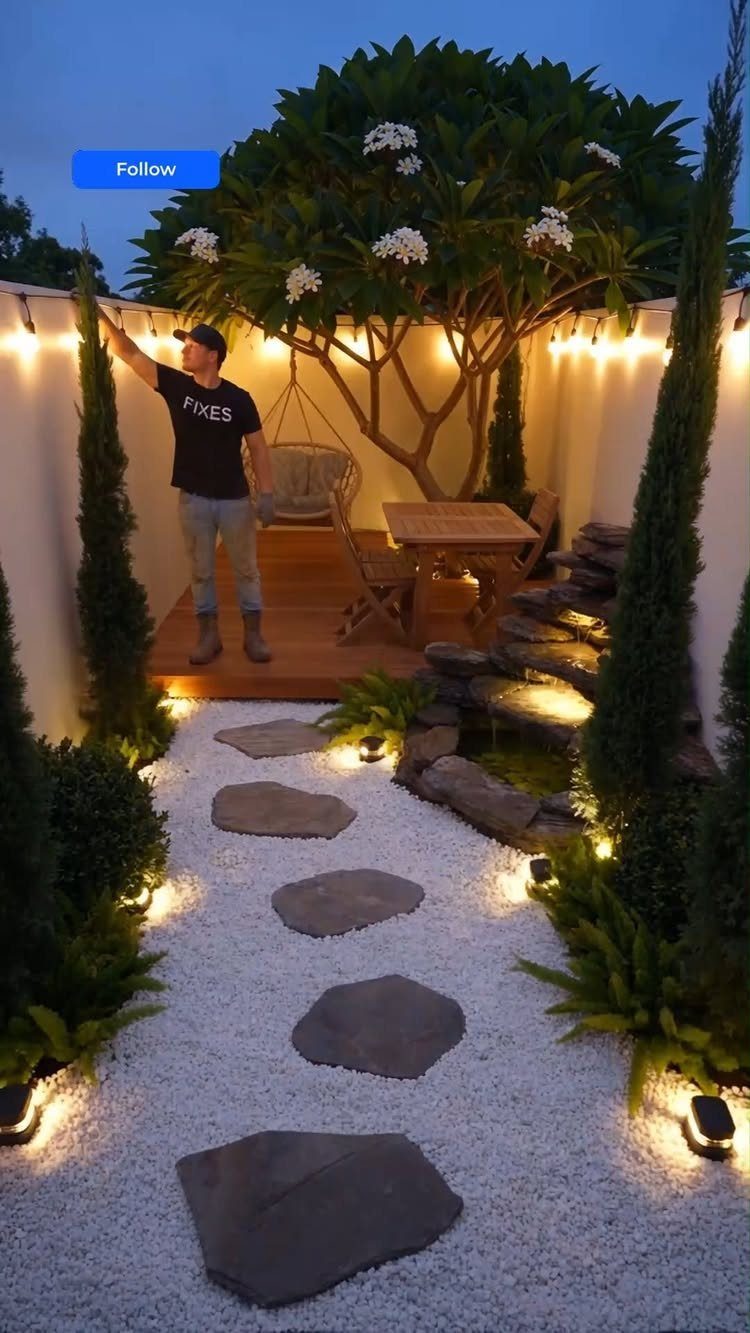 7 Small Yard Garden Ideas for Edibles, Patios and Seating 7 Flagstone stepping stones lead through white gravel toward a wooden deck in a landscaped yard.