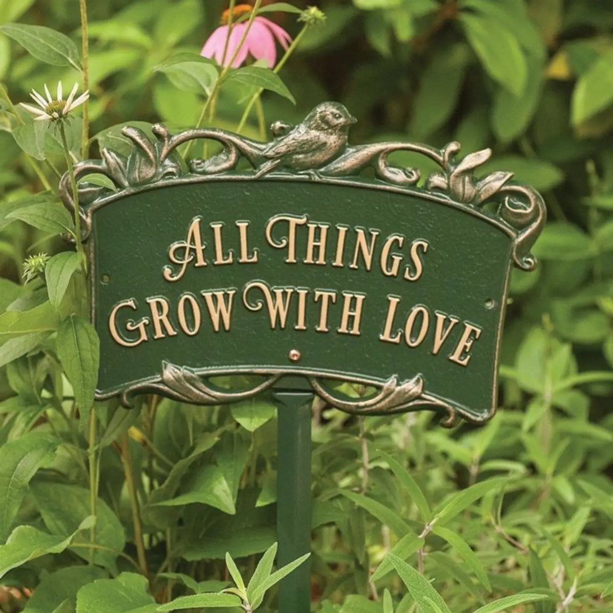 13 Unique Garden Ideas for Planters, Privacy Screens and Pallet Projects 3 Green garden sign with gold text reading All Things Grow With Love amidst green leaves.