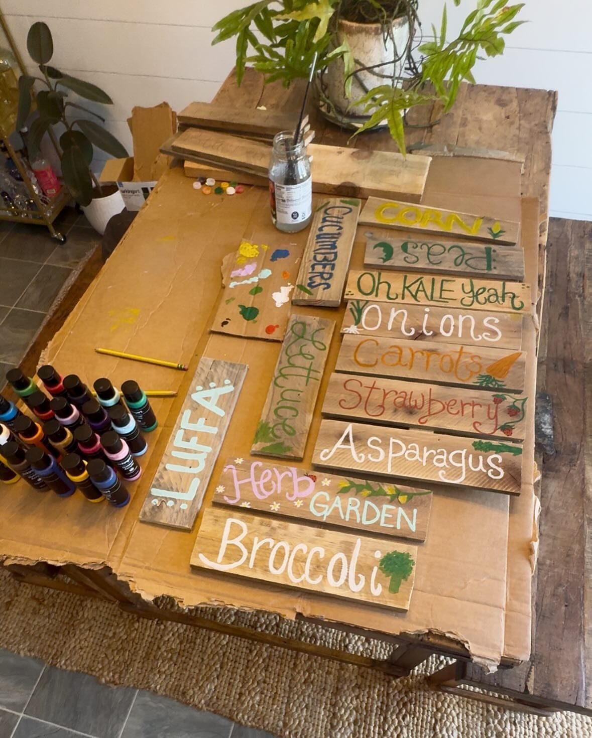 13 Unique Garden Ideas for Planters, Privacy Screens and Pallet Projects 13 Hand-painted wooden garden plant markers scattered on a table with various vegetable names.