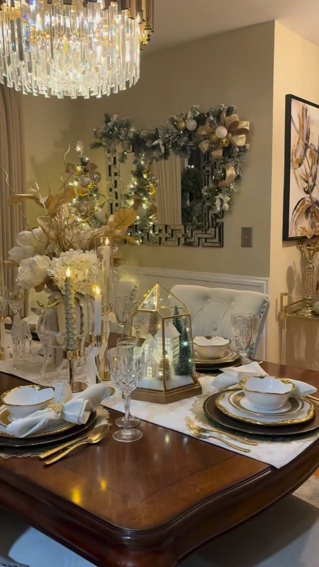 12 Xmas Table Decorations for Pine Cones, Mercury Glass, and Blue-Gold Palettes 5 A formal dining table set with gold-rimmed plates, white linens, and a glass lantern centerpiece.