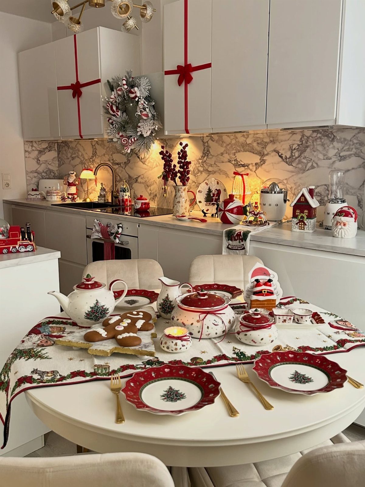 12 Xmas Table Decorations for Pine Cones, Mercury Glass, and Blue-Gold Palettes 10 A festive Christmas table setting with red patterned plates, gingerbread cookies, and holiday themed tableware.